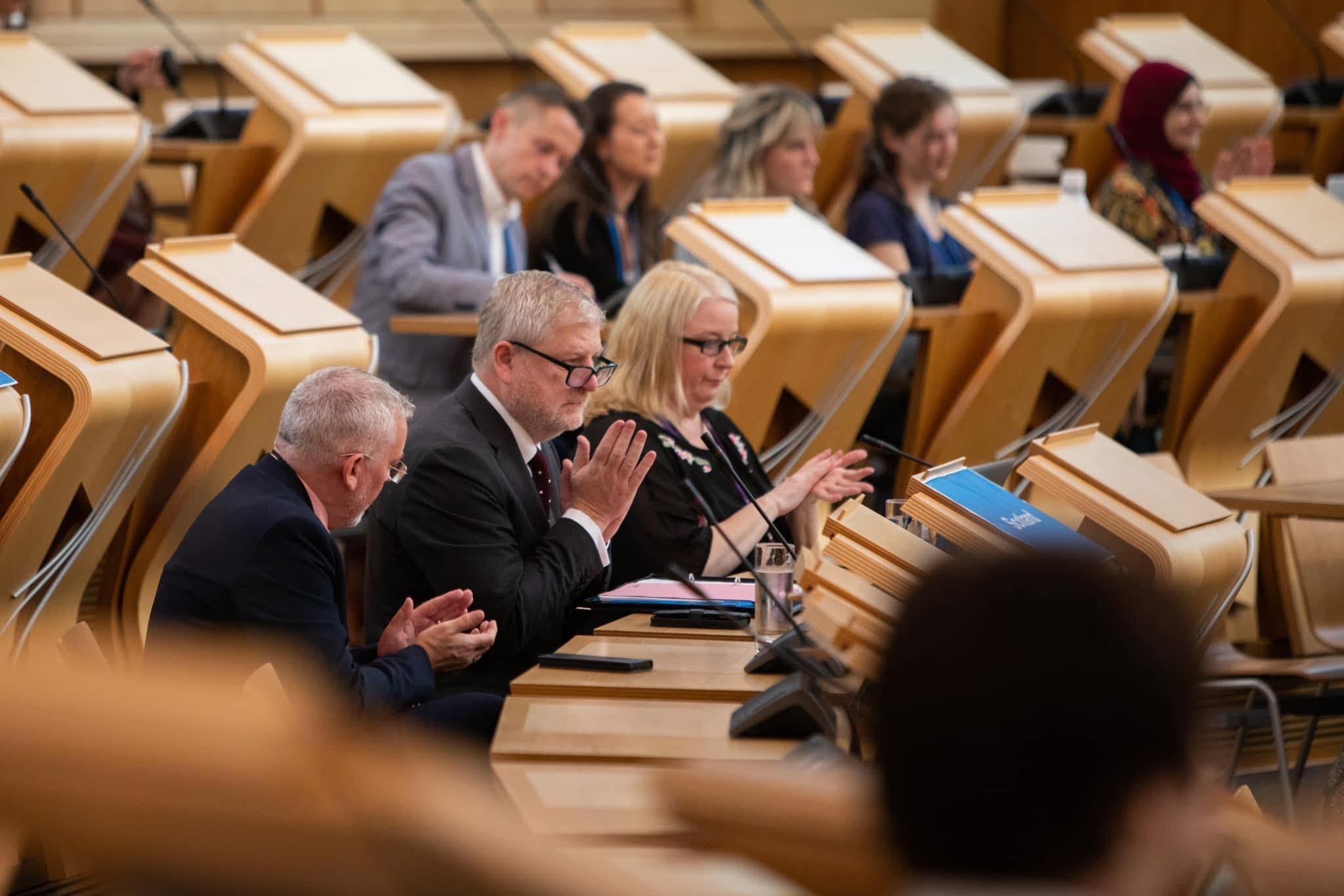 On the Scottish Parliament front bench.