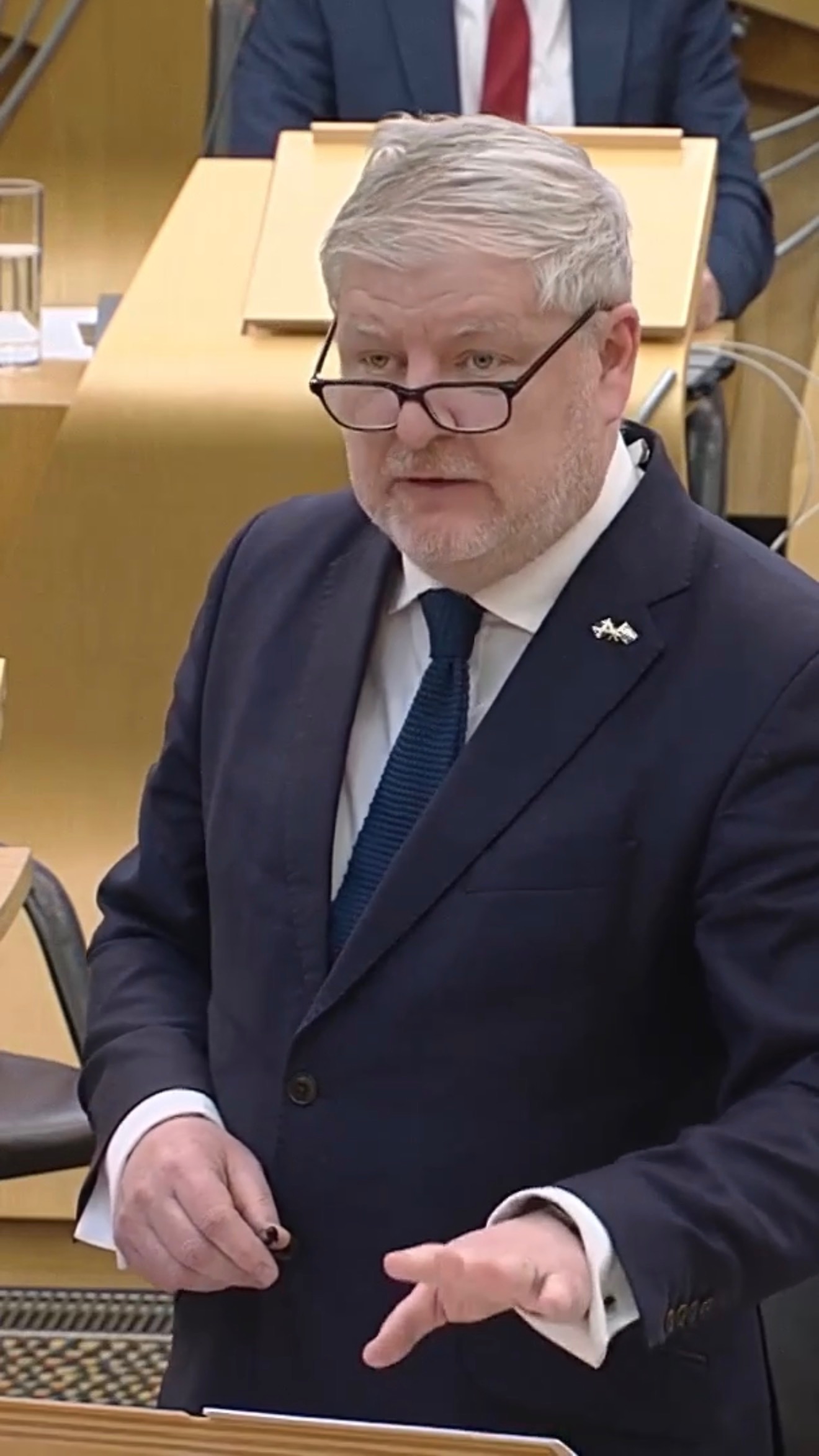 Addressing the Scottish Parliament chamber.